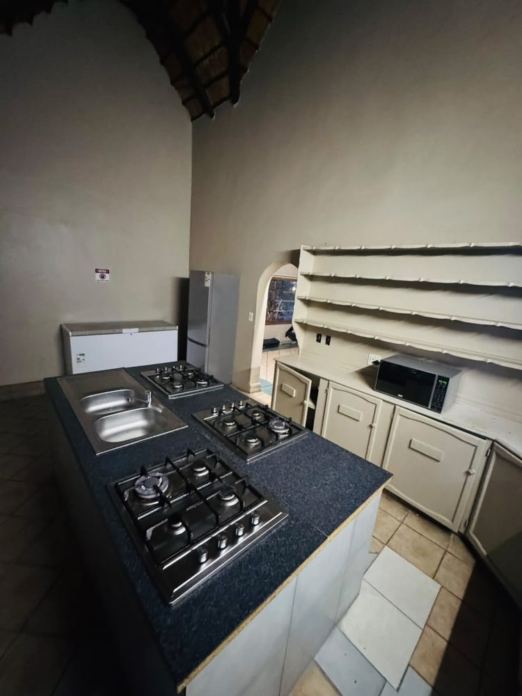 1 Silver Oak — shared kitchen with three gas hobs, double sink, fridge, chest freezer and microwave